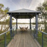 Gazebo with picnic table overlooking water at St Ives Mandurah retirement village